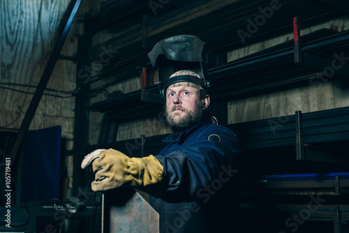 Portrait of welder with beard in workplace