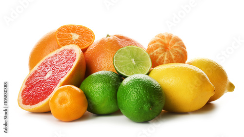 A heap of mixed citrus fruit including lemons, limes, grapefruit and tangerines isolated on a white background, close up