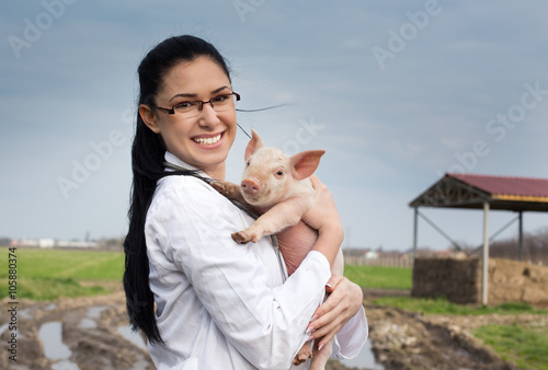 Veterinarian girl with piglet