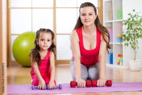 Woman with kid doing gym and fitness exercises