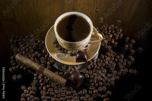 Hot coffee, coffee beans , cigar and chocolate