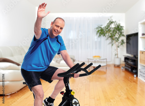 Senior Man cycling on bike trainer.