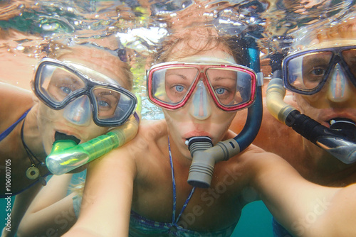 Underwater photo of a young people snorkeling at tropical ocean