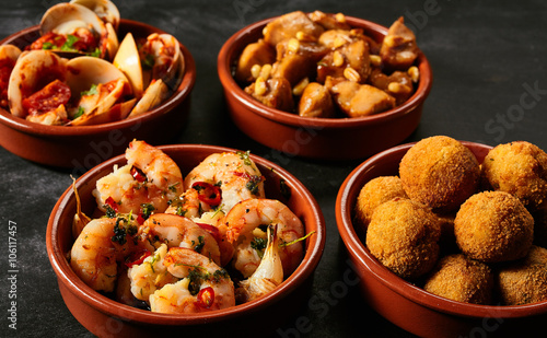 Four bowls of Spanish appetizers