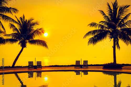 Silhouette coconut palm tree with swimming pool