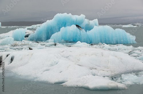 Huge blue and white floes and icebergs at ice lagoon Jokulsarlon, Iceland