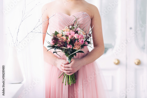 bridal bouquet from pink roses in hands