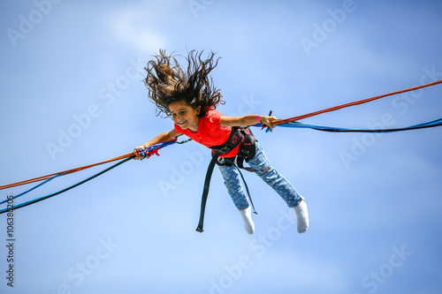 Girl bungee jumping trampoline