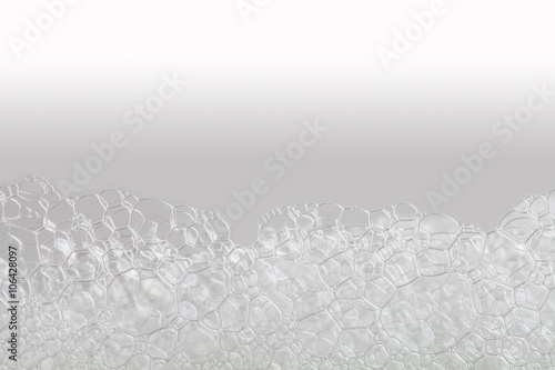 Macro view soapy bubbles foam. suds and shower texture. beige white gradient background. Horizontal, soft focus