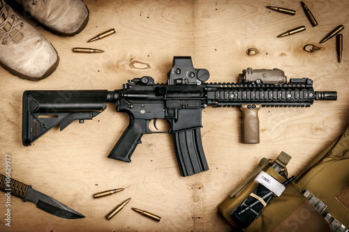 Assault rifle on a wooden table