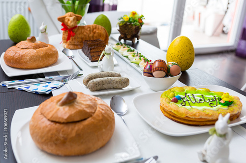 Easter traditional polish breakfast with white borsch soup in bread bowl, eggs and white sausages