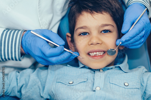 Cute boy having regular dental exam