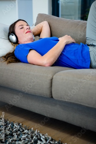 smiling woman listening to music on her headphones