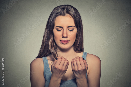 Worried woman looking at hands fingers nails obsessing about cleanliness
