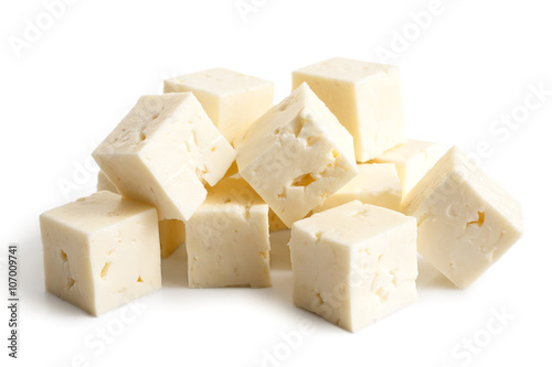 Square cubes of feta cheese isolated on white.