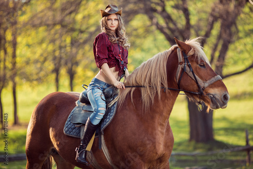Beautiful girl riding horse on autumn field