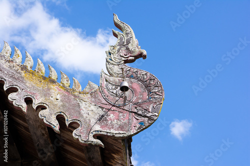 The Old wooden naga on roof, (Northern Thailand temple roof)
