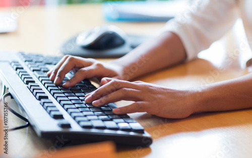 close up of female hands typing on keyboard