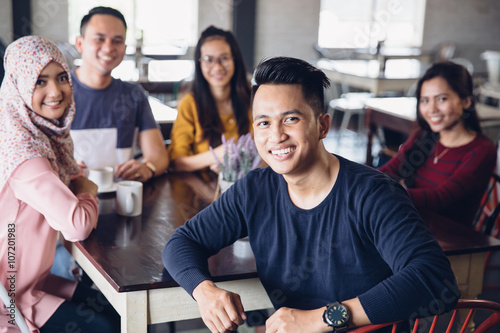 friend having fun together in a cafe