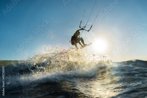 Surfer jumping at the sunset