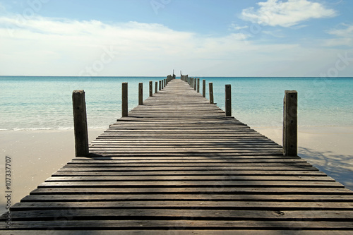 wooden jetty on sunny beach