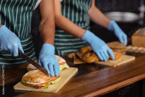 Close up of baristas preparing sandwiches