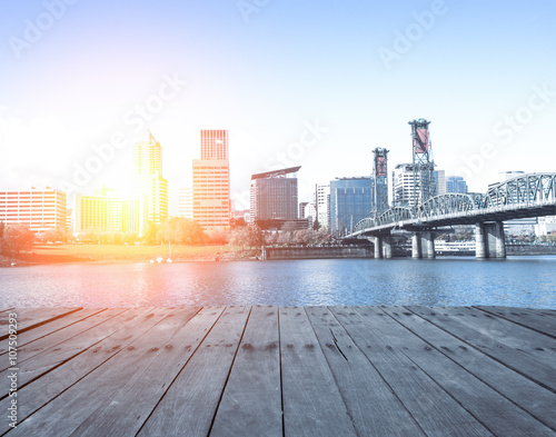 wood floor near bridge with cityscape and skyline of portland at
