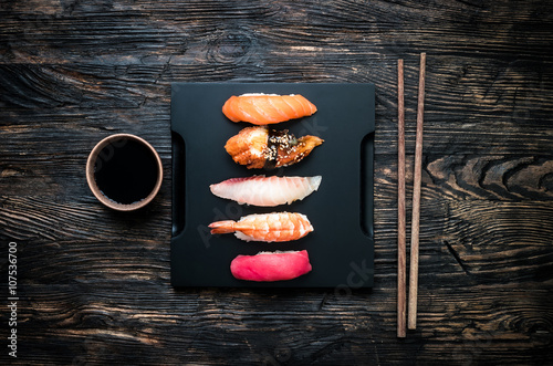 set of sashimi sushi with soy and chopsticks