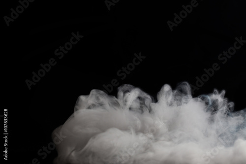 Fluffy Puffs of Smoke and Fog on Black Background with copy space