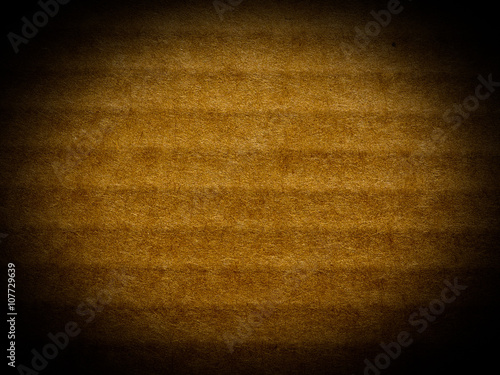 Brown corrugated cardboard background, spotlight vignetted