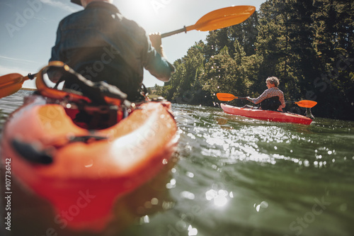 Mature woman kayaking in lake on a sunny day