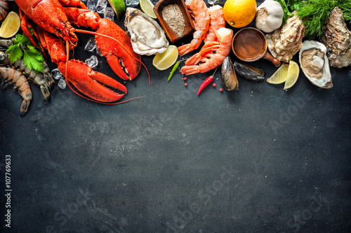 Shellfish plate of crustacean seafood with fresh lobster, mussels, oysters as an ocean gourmet dinner background