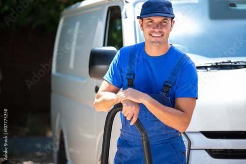 Happy janitor cleaning the car 