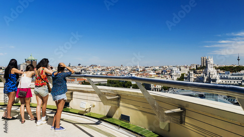 Tourists admire the panoramic view of Madrid from the roof of a