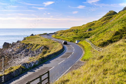 The eastern coast of Northern Ireland and Antrim Coastal road with cars