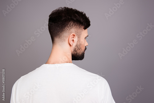 Close up portrait of man's back isolated on gray background