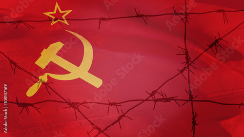 Barbed wire on the background of the flag of the USSR