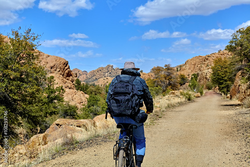Lone Bike Rider on Mountain Trail