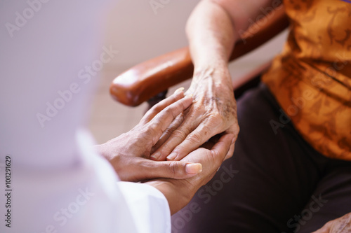 Doctor Vising Senior Woman In Old People Home