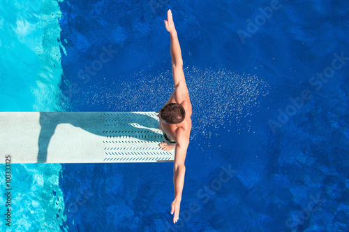 Diver on the springboard, ready to jump backwards
