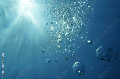 Underwater bubbles with sunlight through water surface, natural scene, Caribbean sea