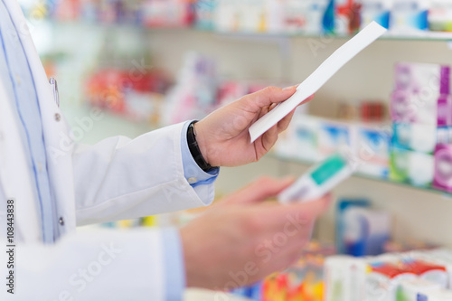 Pharmacist filling prescription in pharmacy