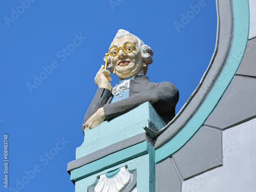 Sculpture of a man looking through lorgnette in Tallin, Estonia