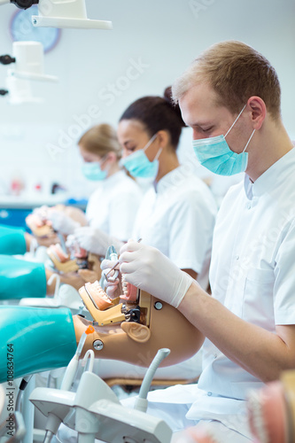 Students of medicine in dental cabinet