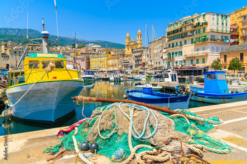 Traditional fishing boats in Bastia port on sunny summer day, Corsica island, France