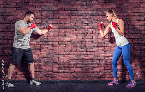 Two figters on the Brick wall background are rady for sparring