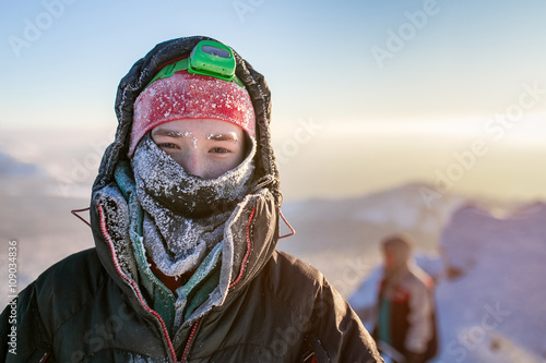 Frost Portrait of a hiker Climber. Wrapped in frosty hat and sca