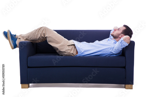 handsome man lying on sofa isolated on white