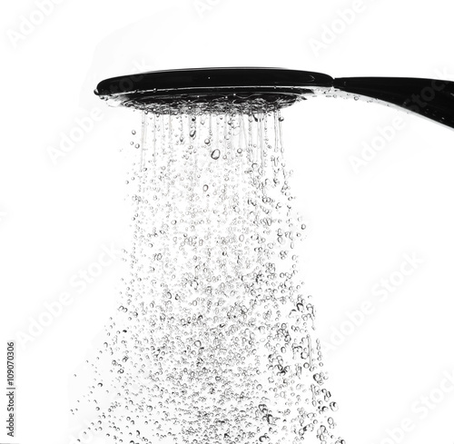 Water drops from shower head in bathroom on white background