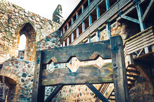 Wooden medieval torture device, ancient pillory in old castle.